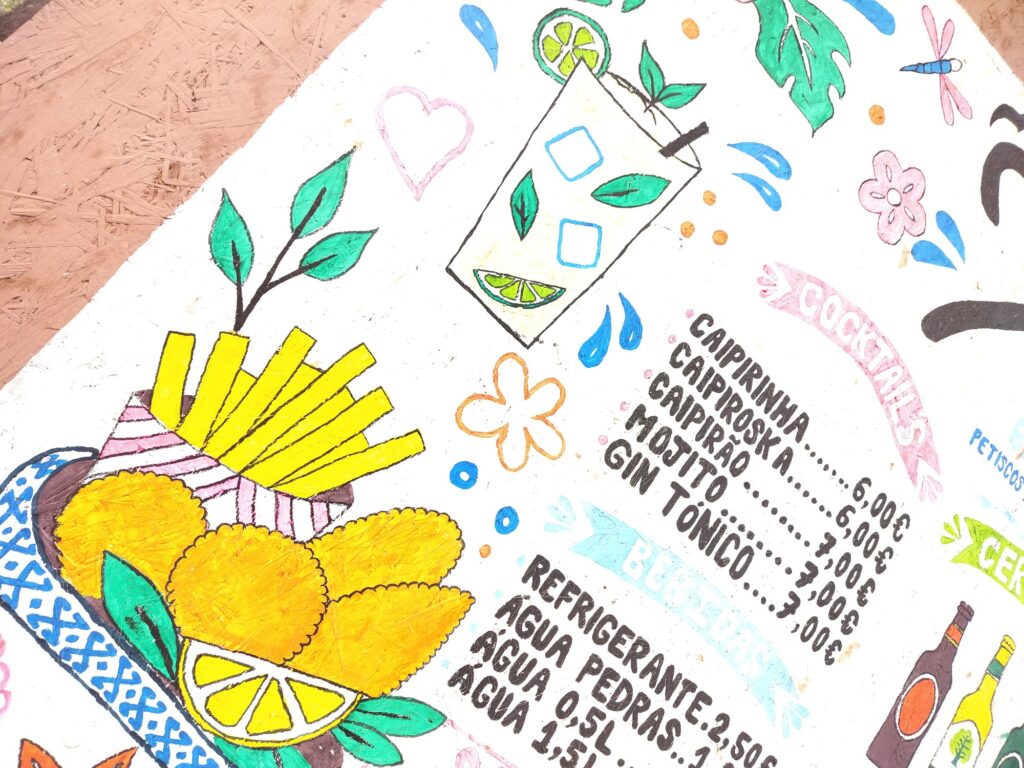 Painted illustrations of fries and golden fried pastries, a cocktail with a lime slice, and the cocktail price list.